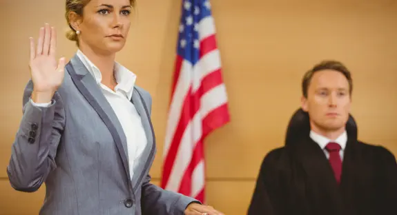 Witness swearing on the bible telling the truth in the court room